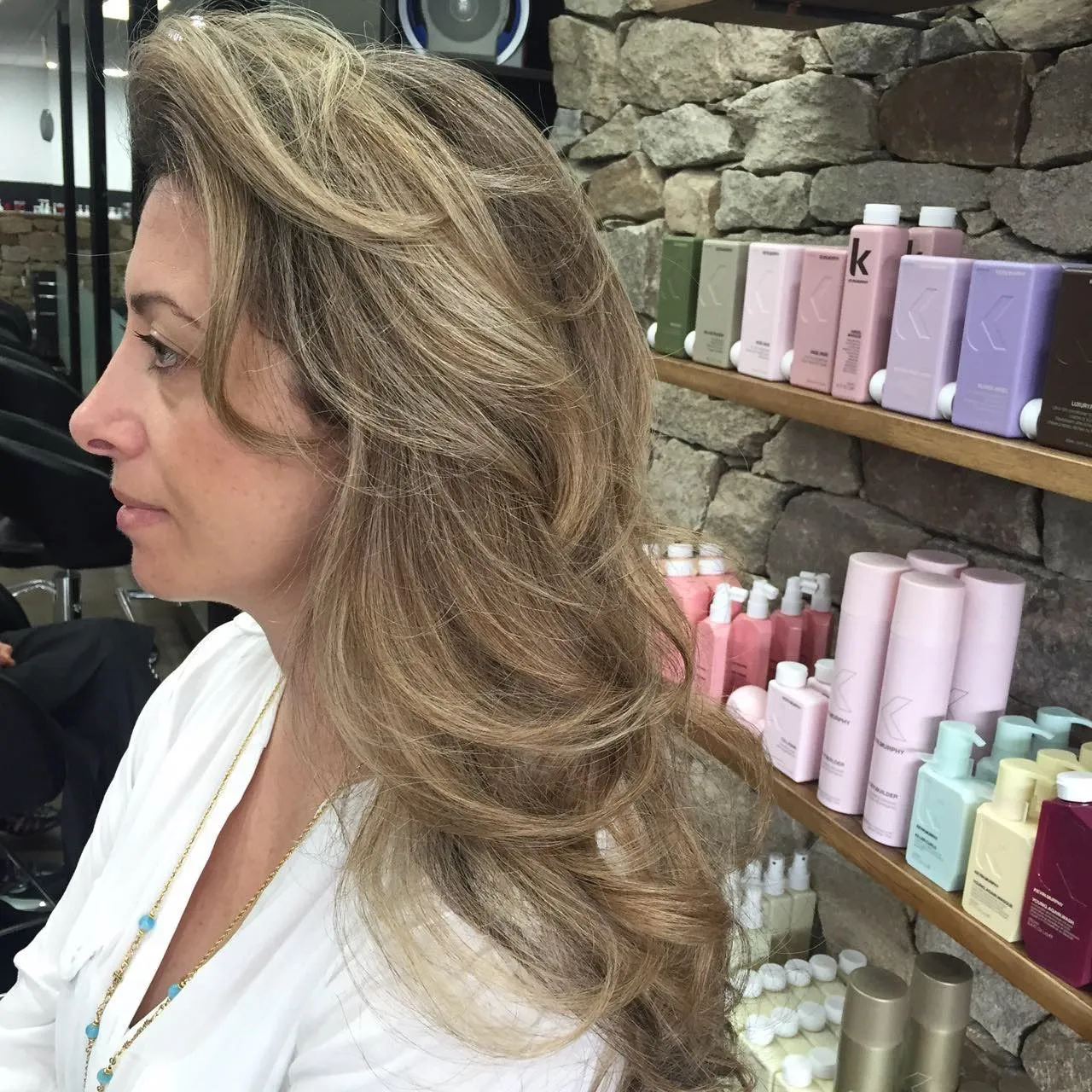 Sandy blonde balayage with long wavy hair at DC Hair Lounge Baulkham Hills