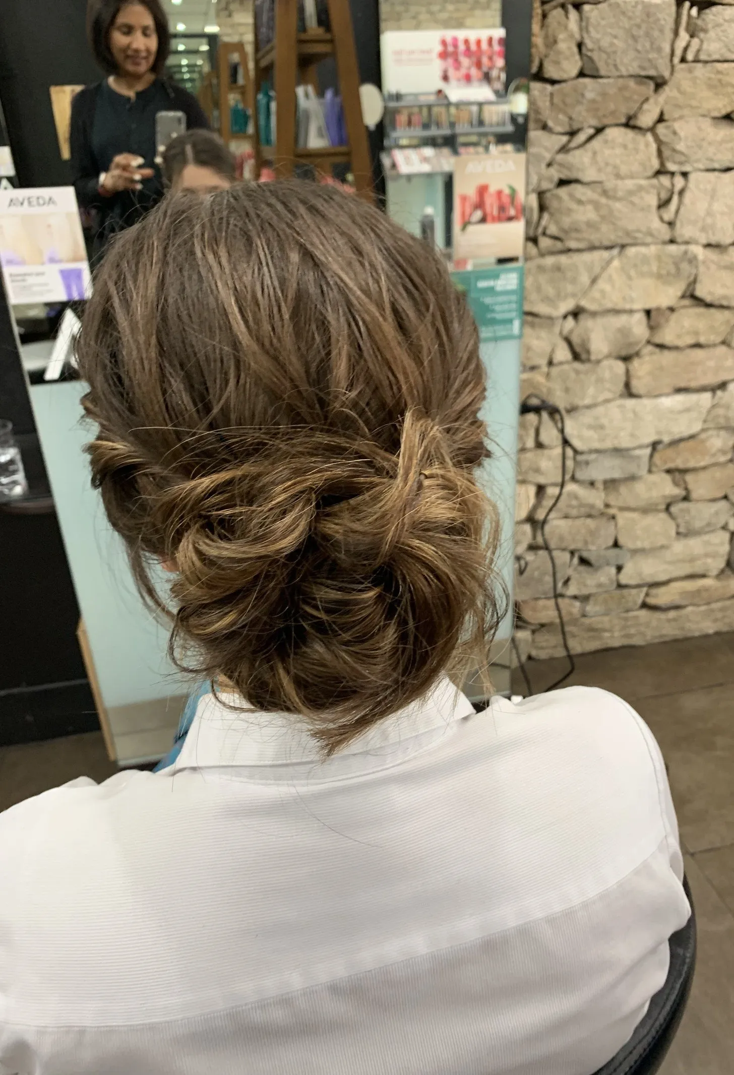 Brunette low chignon updo at DC Hair Lounge Baulkham Hills